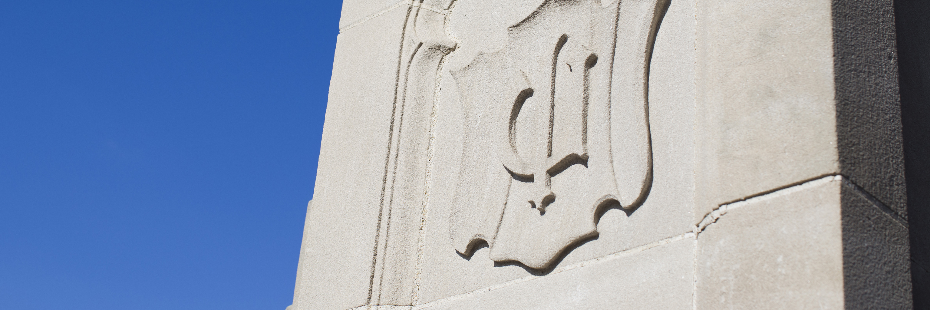 Image of a symbol carved in limestone within the Bloomington campus arboretum. 