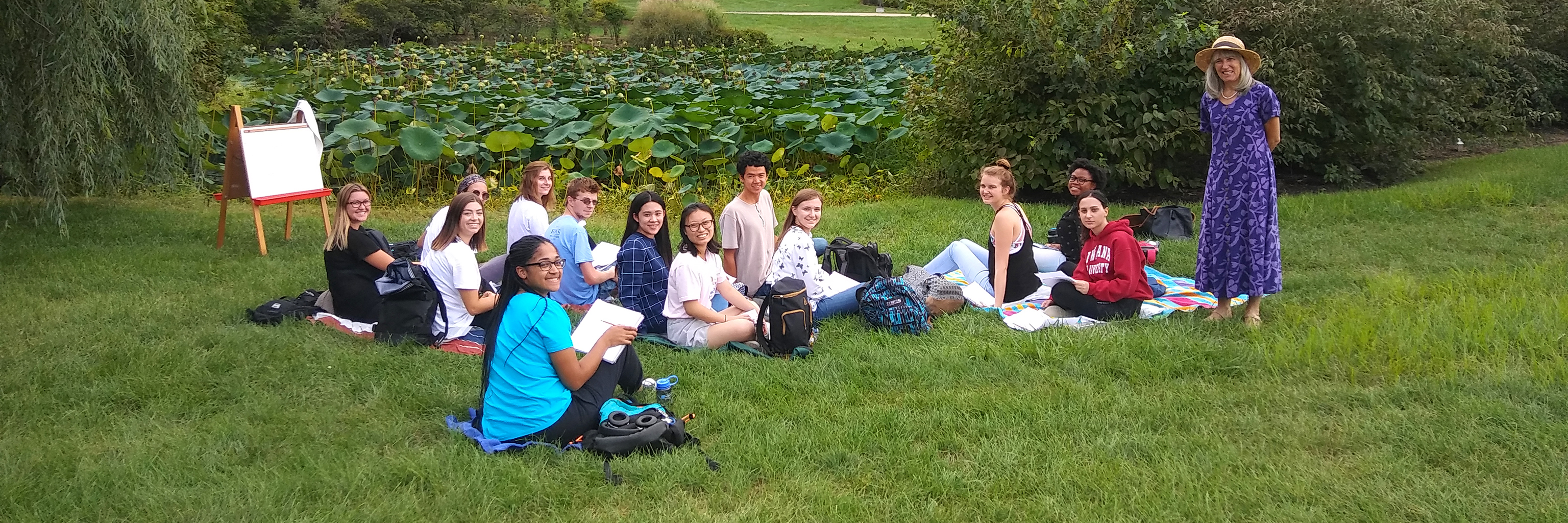 Image of French class meeting outside on the picturesque Indiana University lawn.