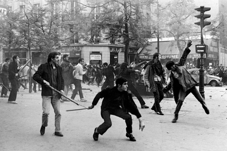 Students hurling projectiles against the police in Paris, France in 1968.