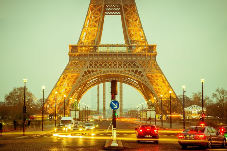 Street traffic below the Eiffel Tower in Paris, France.