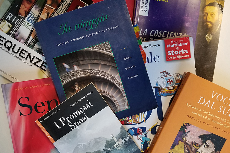 Italian textbooks spread out on a table.