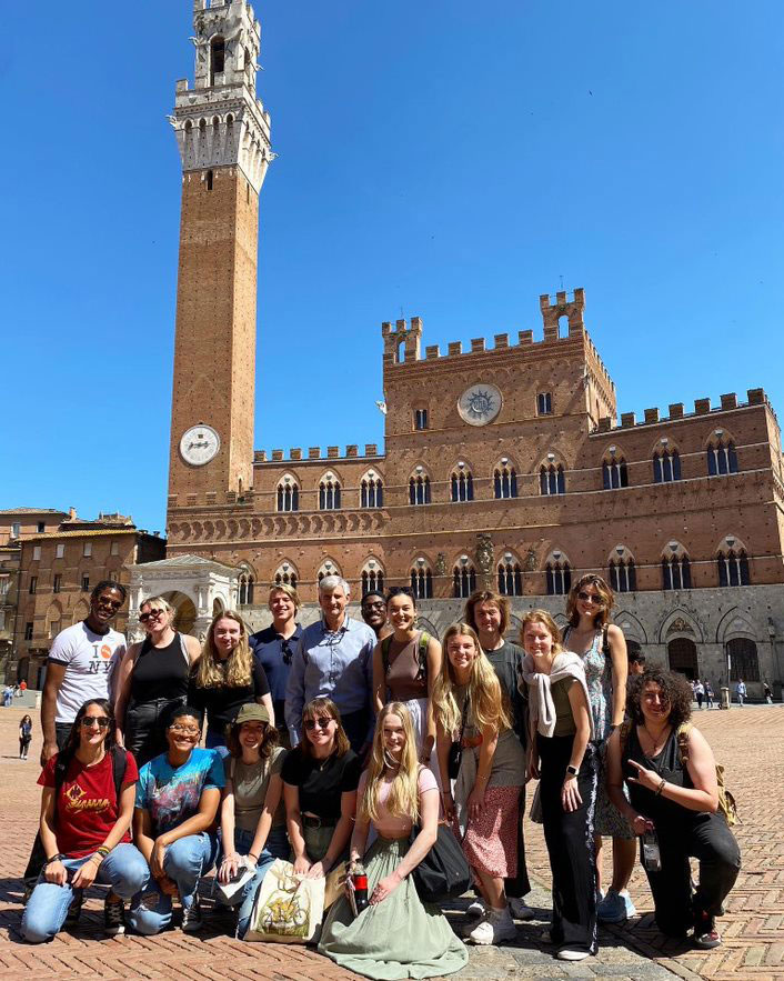 Florence summer study abroad program students on a day trip to Siena (Piazza del Campo). Program director Andrea Ciccarelli is at center, and Associate Instructor Pantalea Mazzitello (MA ‘18) is at left.