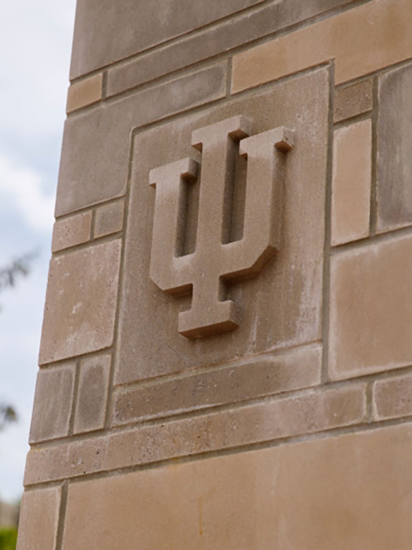 The IU trident relieved on a limestone pillar.