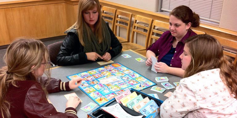 Students play a board game during French Club.