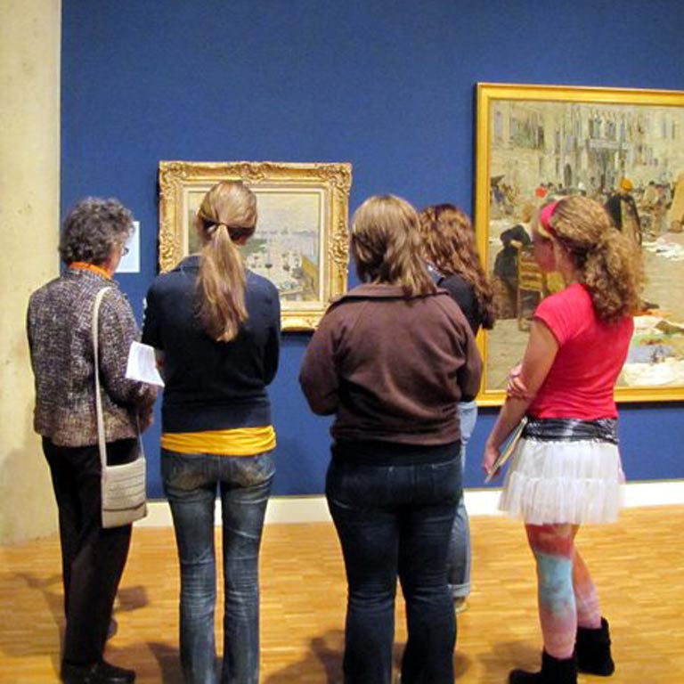 Students viewing art in an art museum. 