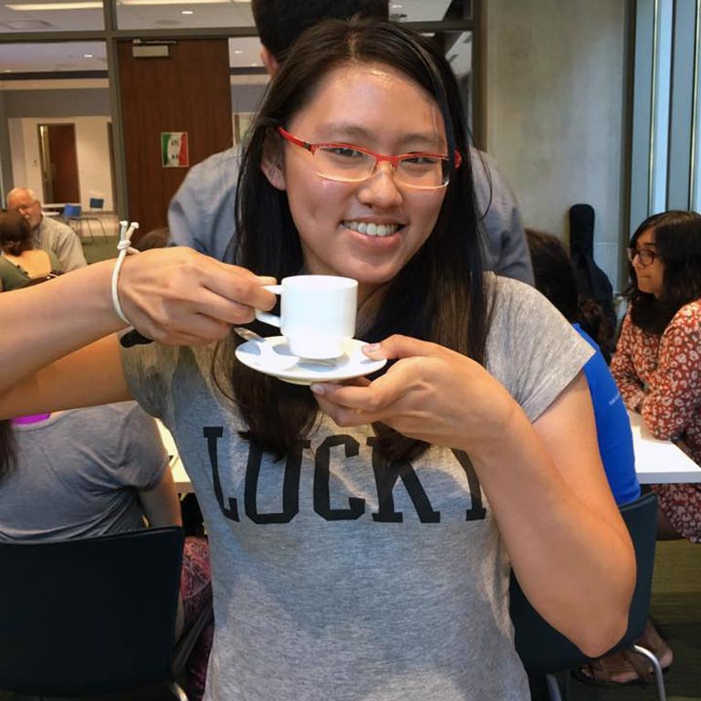 Student poses for photo with espresso cup.